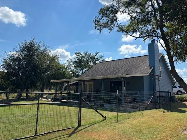 a view of a house with backyard and sitting area