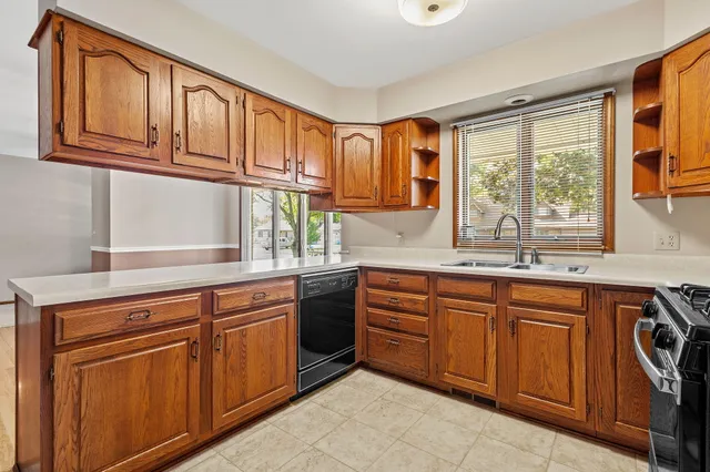 a kitchen with stainless steel appliances granite countertop a sink and cabinets