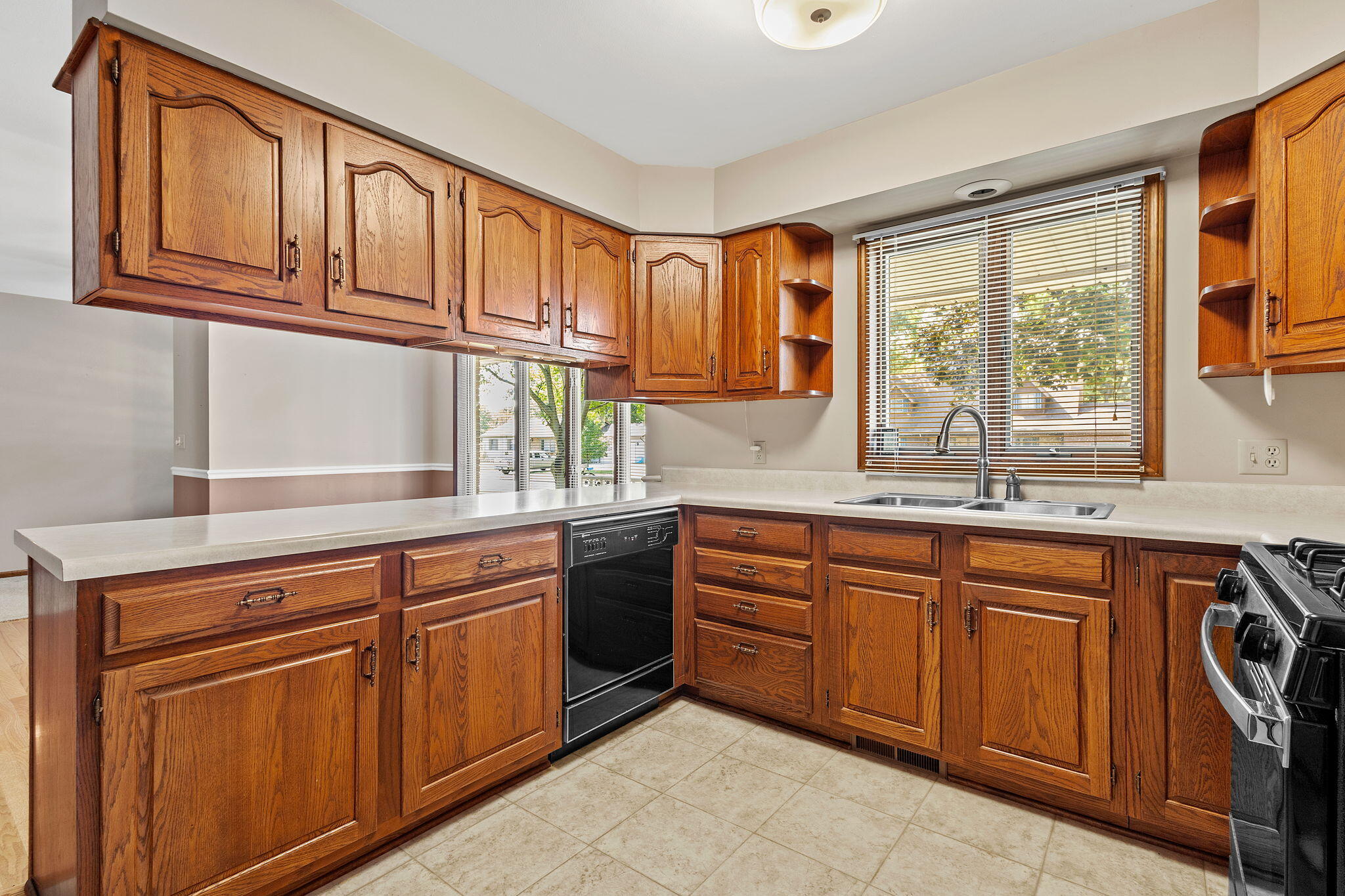 1905 Juniper Street Southwest De Motte, IN 46310 - Photo 11 of 42 a kitchen with stainless steel appliances granite countertop a sink and cabinets
