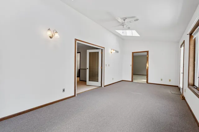 an empty room with fan and entrance