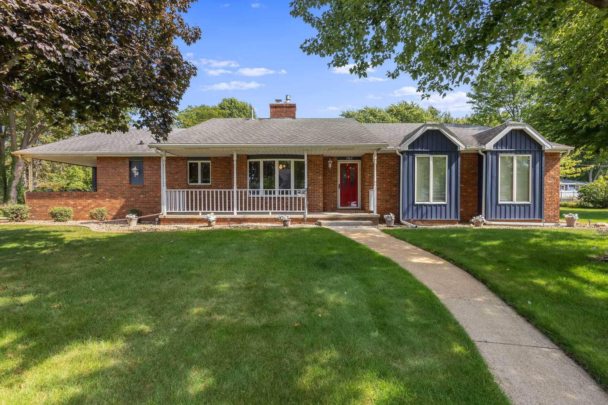 1905 Juniper Street Southwest De Motte, IN 46310 - Photo 33 of 42 a front view of a house with a garden and trees
