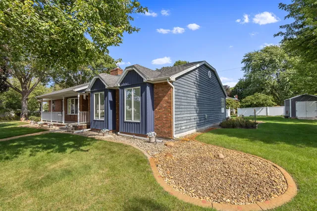 a view of a house with backyard and sitting area