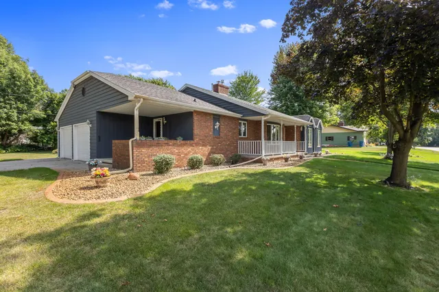 a view of a house with backyard and sitting area