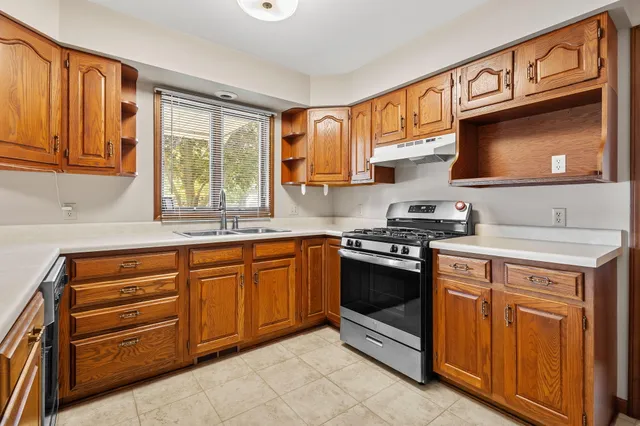 a kitchen with stainless steel appliances granite countertop a stove microwave and cabinets