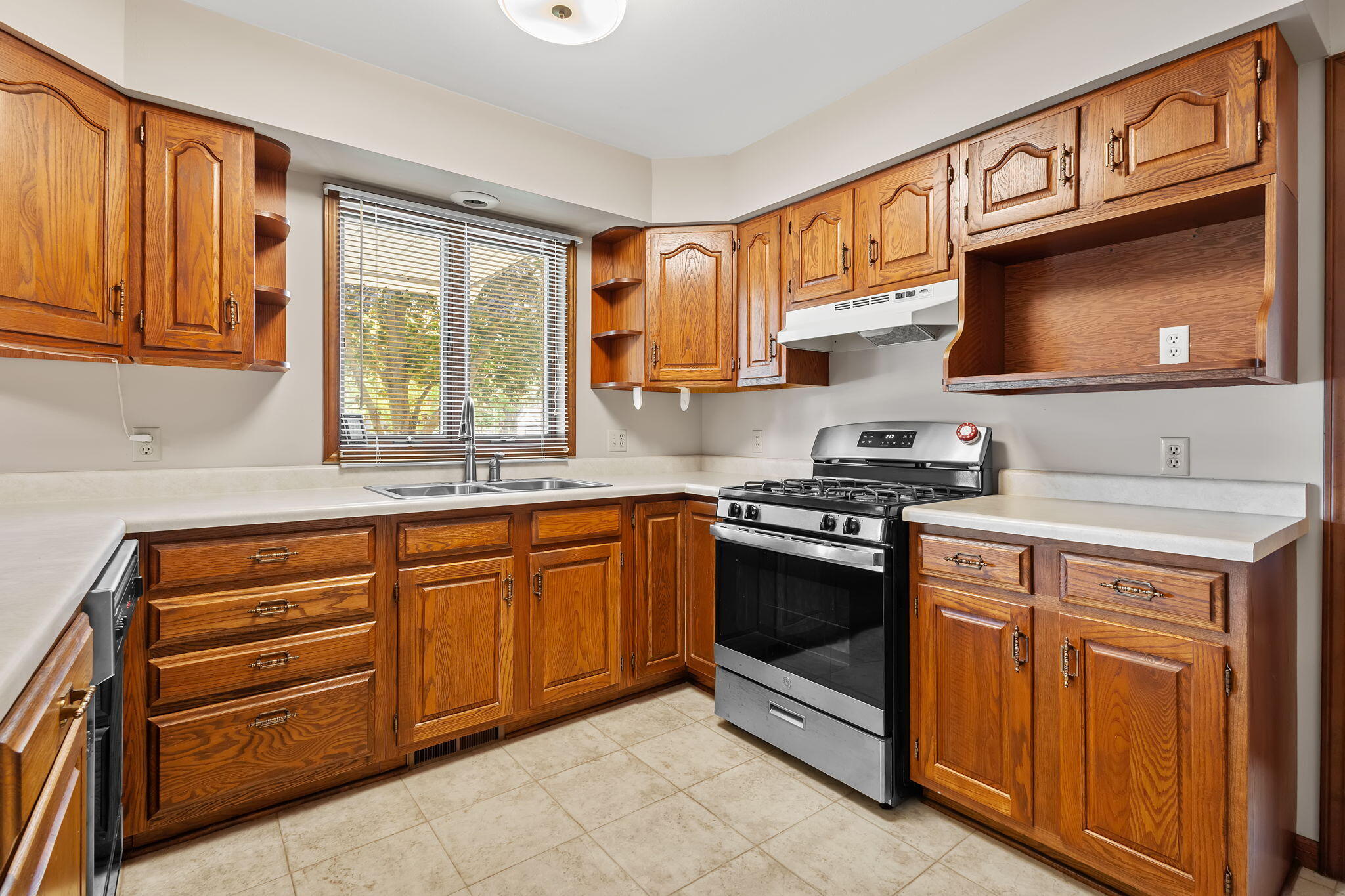 1905 Juniper Street Southwest De Motte, IN 46310 - Photo 10 of 42 a kitchen with stainless steel appliances granite countertop a stove microwave and cabinets
