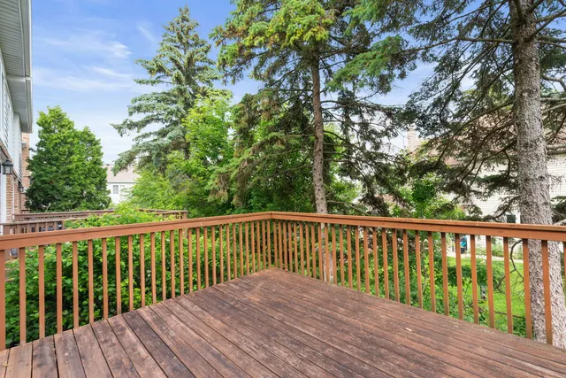 a balcony with wooden floor and fence