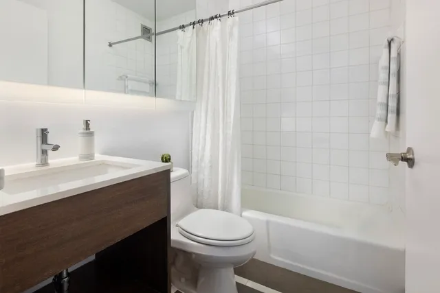 a kitchen with stainless steel appliances granite countertop white cabinets and a sink