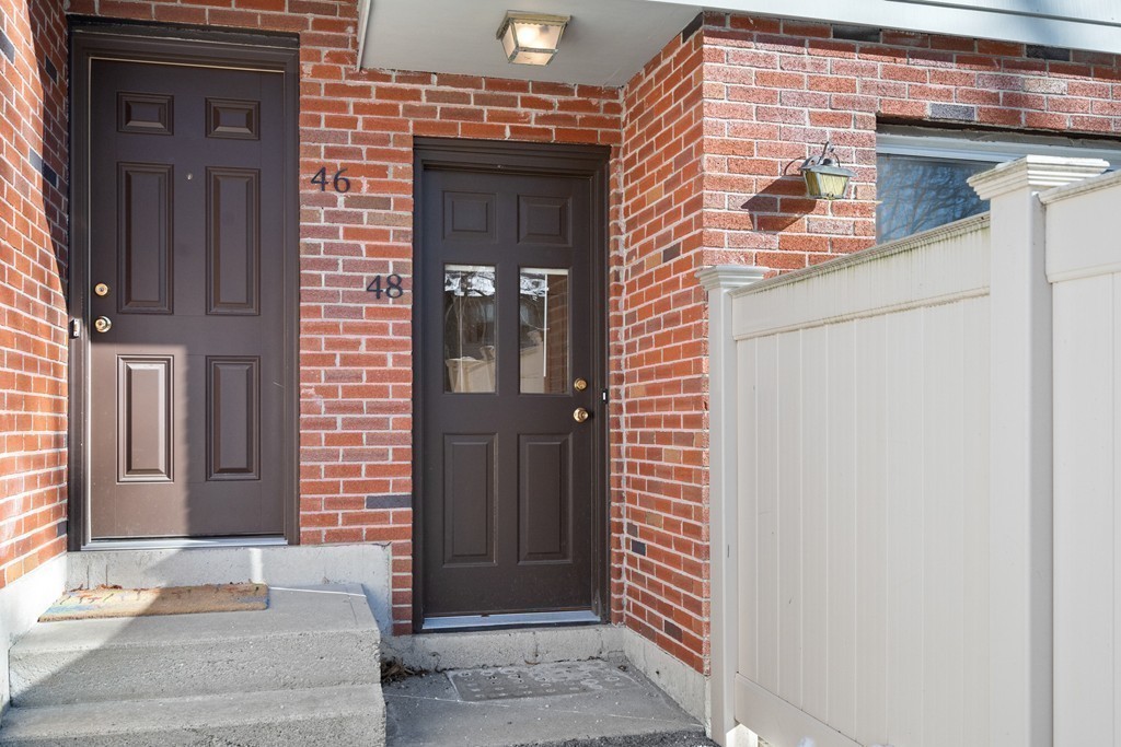 48 Regent Circle, Unit 48 Brookline, MA 02445 - Photo 13 of 14 a front view of a house with a white door