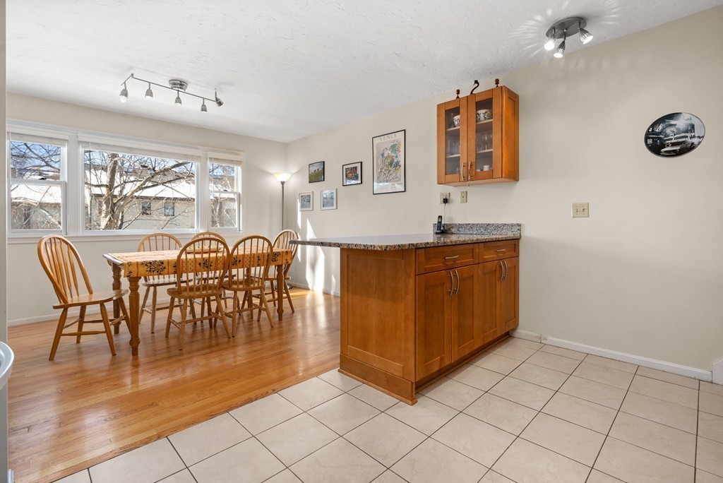 48 Regent Circle, Unit 48 Brookline, MA 02445 - Photo 3 of 14 a view of a dining room with furniture and chandelier