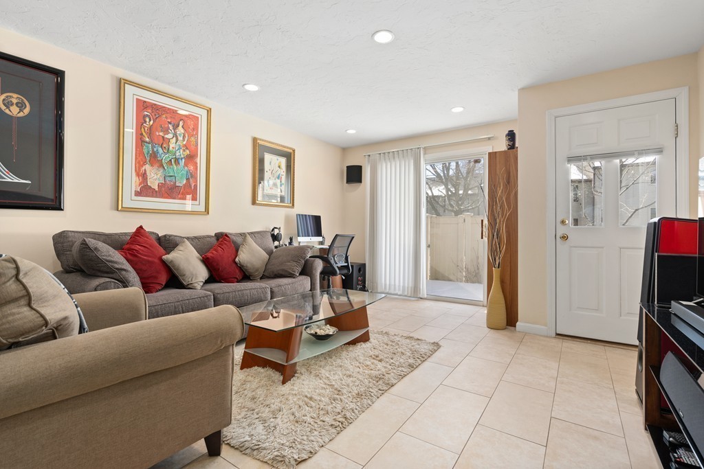 48 Regent Circle, Unit 48 Brookline, MA 02445 - Photo 7 of 14 a living room with furniture and a flat screen tv