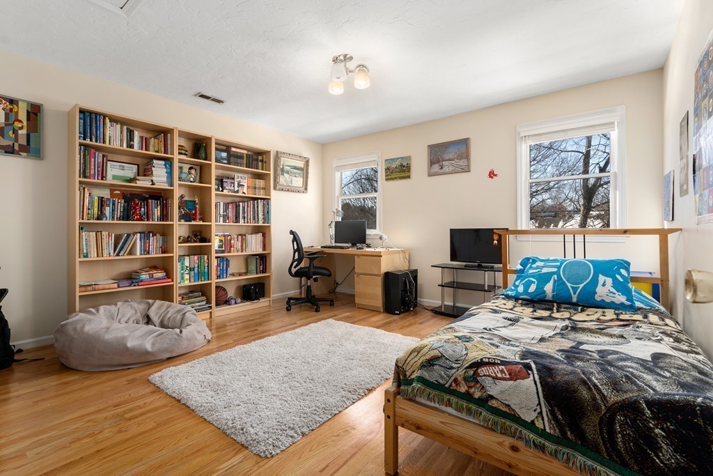 48 Regent Circle, Unit 48 Brookline, MA 02445 - Photo 8 of 14 a bedroom with furniture and a book shelf