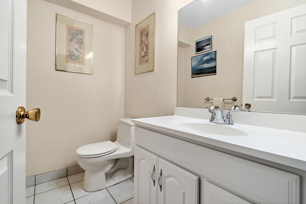 48 Regent Circle, Unit 48 Brookline, MA 02445 - Photo 9 of 14 a bathroom with a toilet sink and mirror