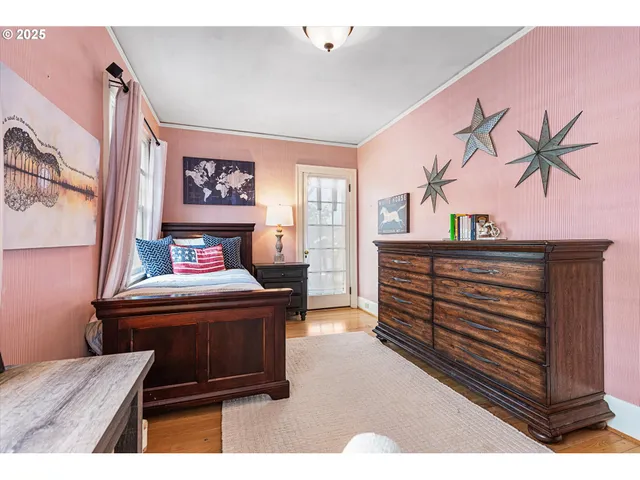 a living room with furniture and a painting on the wall