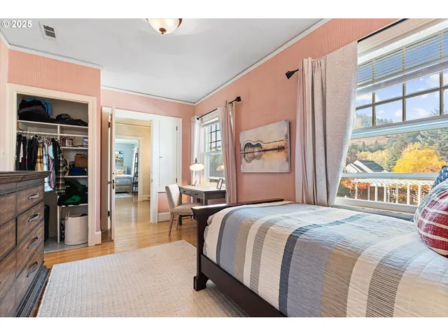 a bedroom with a large bed and a window