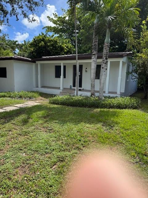 905 Tangier Street Coral Gables, FL 33134 - Photo 2 of 7 a backyard of a house with lots of green space