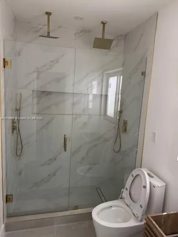 a bathroom with a toilet and shower