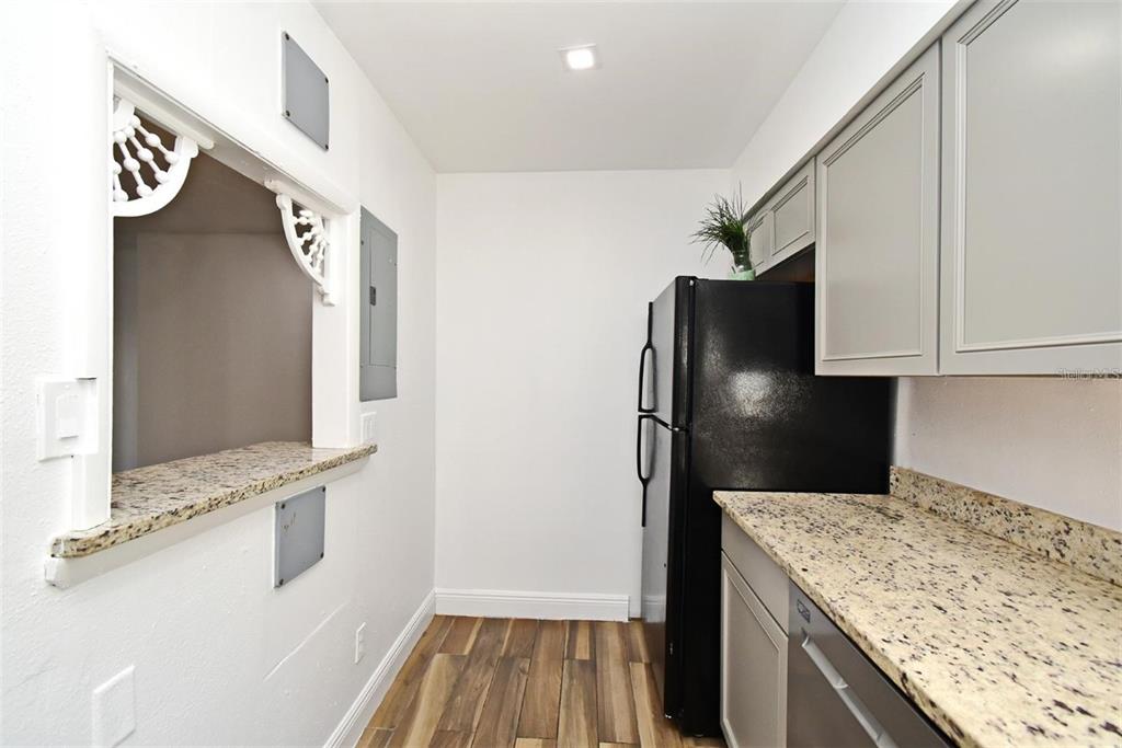 3057 Aaron Burr Avenue, Unit 1 Winter Park, FL 32792 - Photo 3 of 11 a kitchen with a refrigerator and a sink
