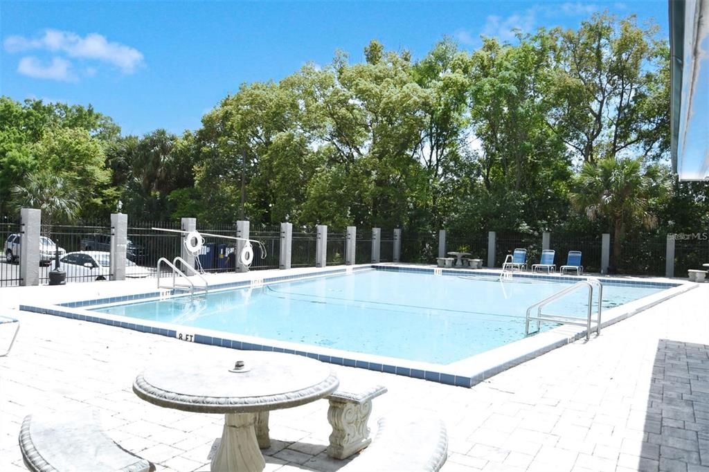 3057 Aaron Burr Avenue, Unit 1 Winter Park, FL 32792 - Photo 4 of 11 a view of a swimming pool with a lounge chair