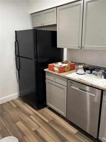 a kitchen with a refrigerator and a sink
