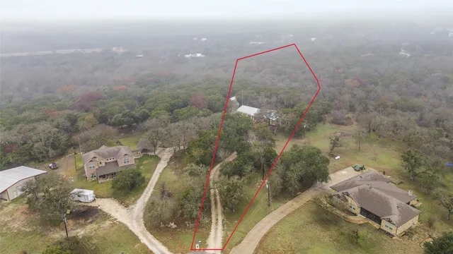 an aerial view of a house with yard and outdoor seating