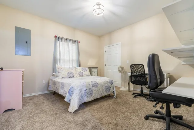 a bedroom with a bed and a chair