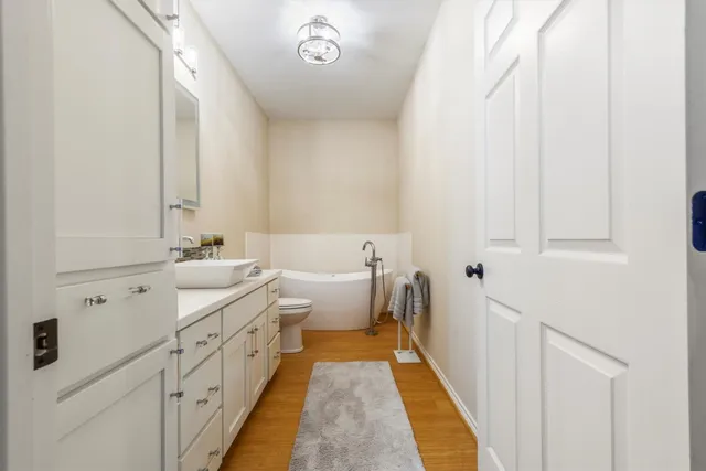 a bathroom with a granite countertop sink a toilet and a mirror