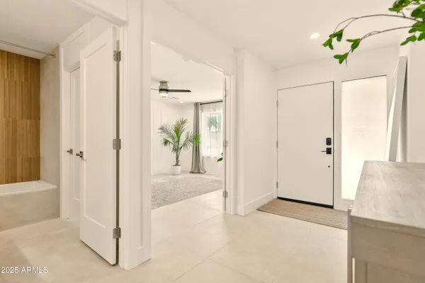 a bathroom with a granite countertop sink a mirror and a shower