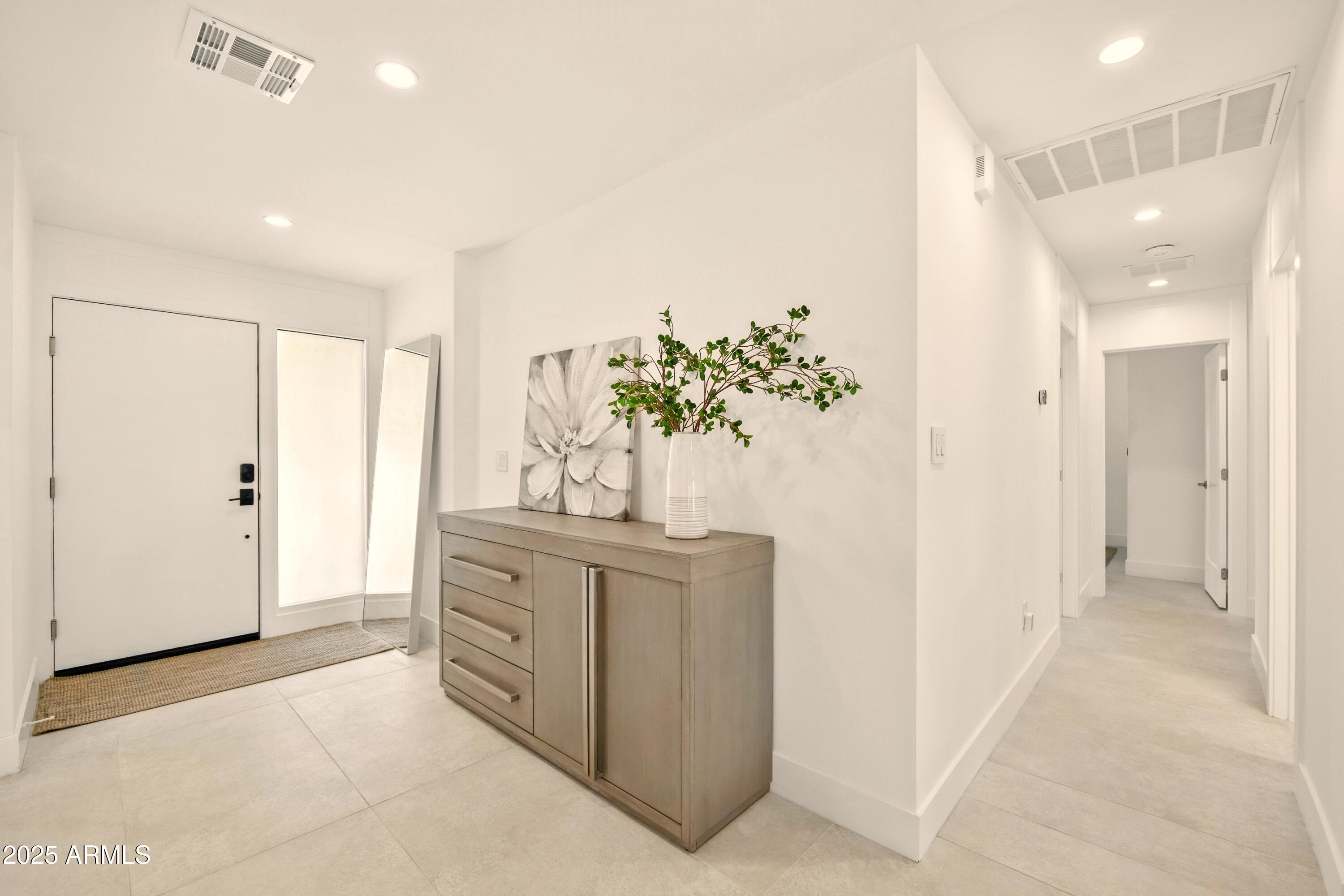 2425 West Impala Circle Mesa, AZ 85202 - Photo 11 of 55 a bathroom with a granite countertop sink a mirror and a shower