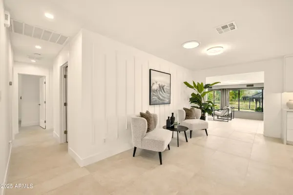 a living room with furniture and a potted plant