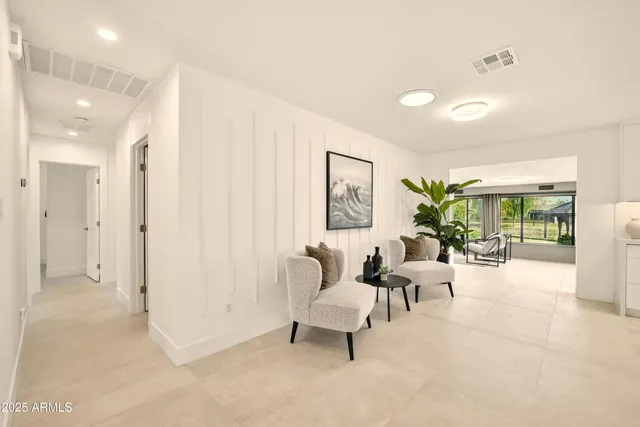 a living room with furniture and a potted plant