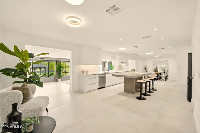 a kitchen with kitchen island white cabinets and chairs