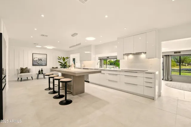 a large kitchen with a large counter top appliances and cabinets