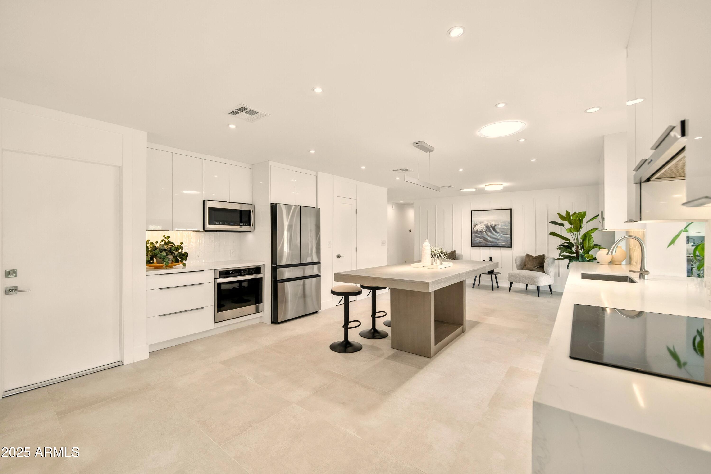 2425 West Impala Circle Mesa, AZ 85202 - Photo 16 of 55 a large kitchen with a large counter top appliances and cabinets