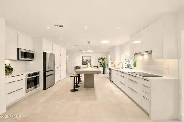 a living room with stainless steel appliances kitchen island furniture and a view of living room