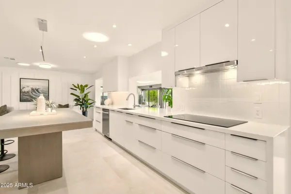 a view of a livingroom with furniture and kitchen view