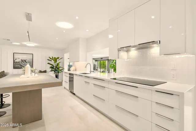 a view of a livingroom with furniture and kitchen view