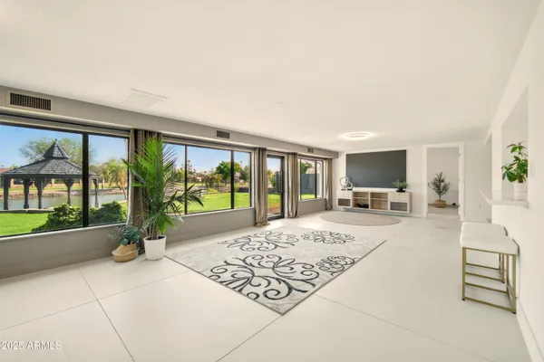 a living room with furniture and a floor to ceiling window