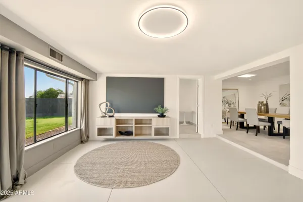 a view of a livingroom with furniture wooden floor and a rug