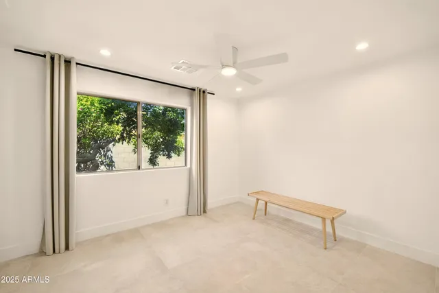 an empty room with windows and closet