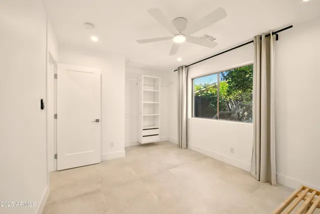 a view of a livingroom with a potted plant and wooden floor