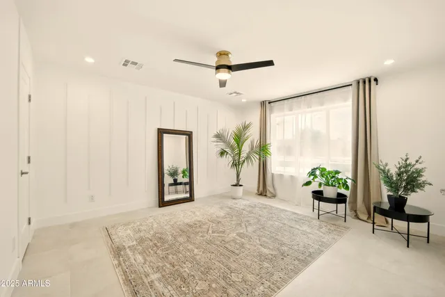 a bed room with a bed and a large window