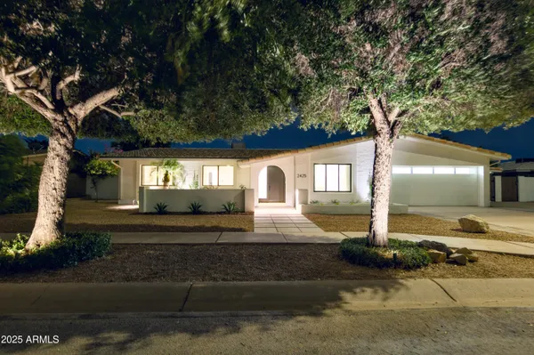 a front view of a house with garden