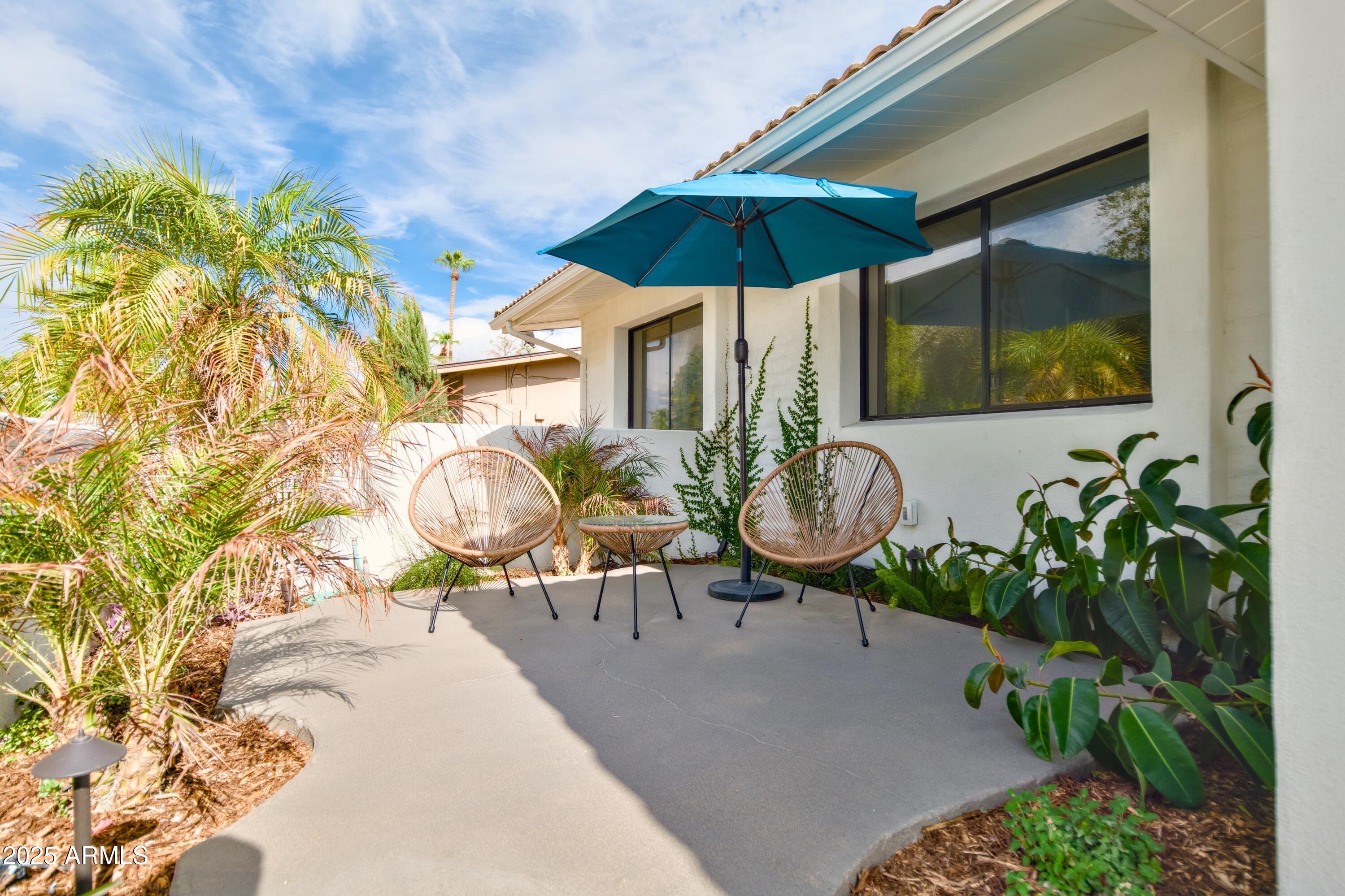 2425 West Impala Circle Mesa, AZ 85202 - Photo 8 of 55 a view of a chair and table in the patio