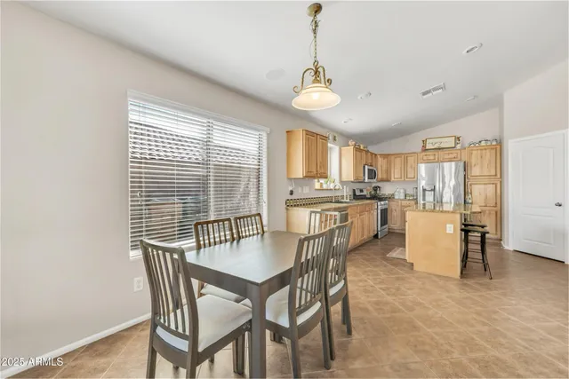 a kitchen with stainless steel appliances granite countertop a refrigerator a stove top oven a sink and dishwasher