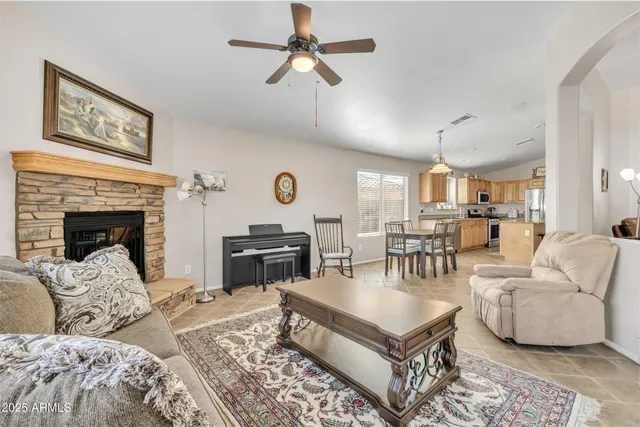 a living room with furniture a fireplace and a window
