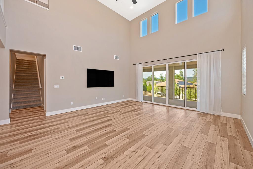 504 Chase Court Colfax, CA 95713 - Photo 42 of 94 a view of an empty room with wooden floor and a window