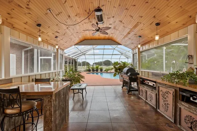a living room with furniture pool table and paintings on the wall