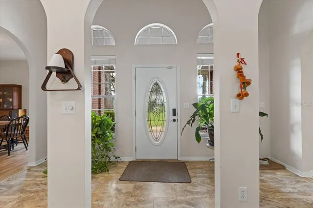 a living room with a fireplace and a floor to ceiling window