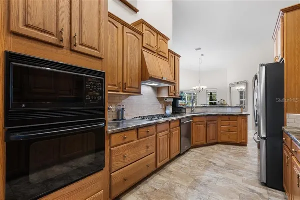 a bathroom with a granite countertop sink a toilet and a mirror