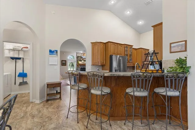a bedroom with a bed and a flat tv screen on dresser